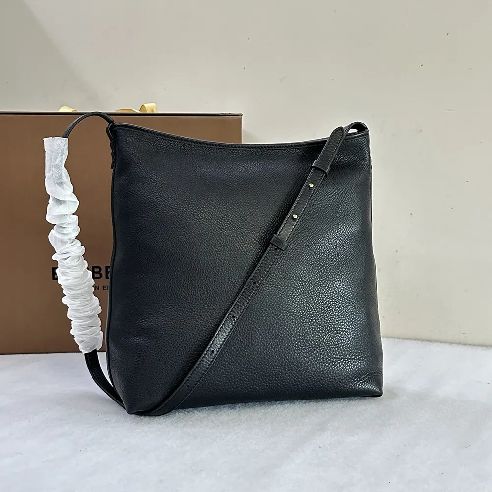 Side angle showing adjustable strap on Burberry Unisex Small Highlands Shoulder Bag-Black