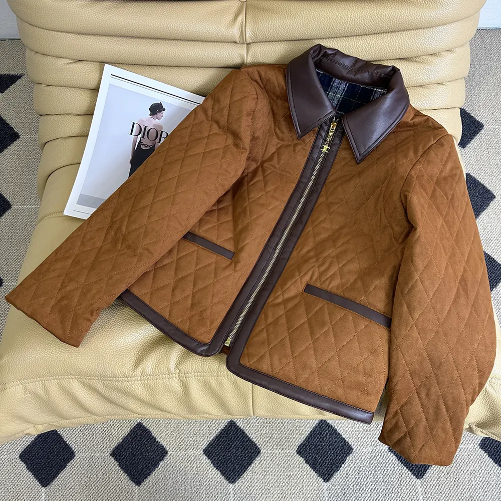 Close-up of quilted suede texture and gold hardware on Celine jacket