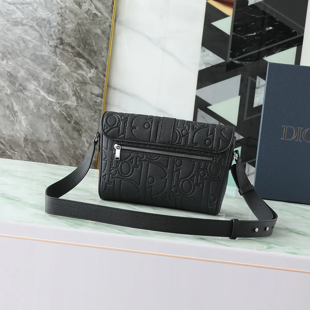 Side angle showing texture and matte hardware on Dior Men Medium Dior Daily Messenger Bag