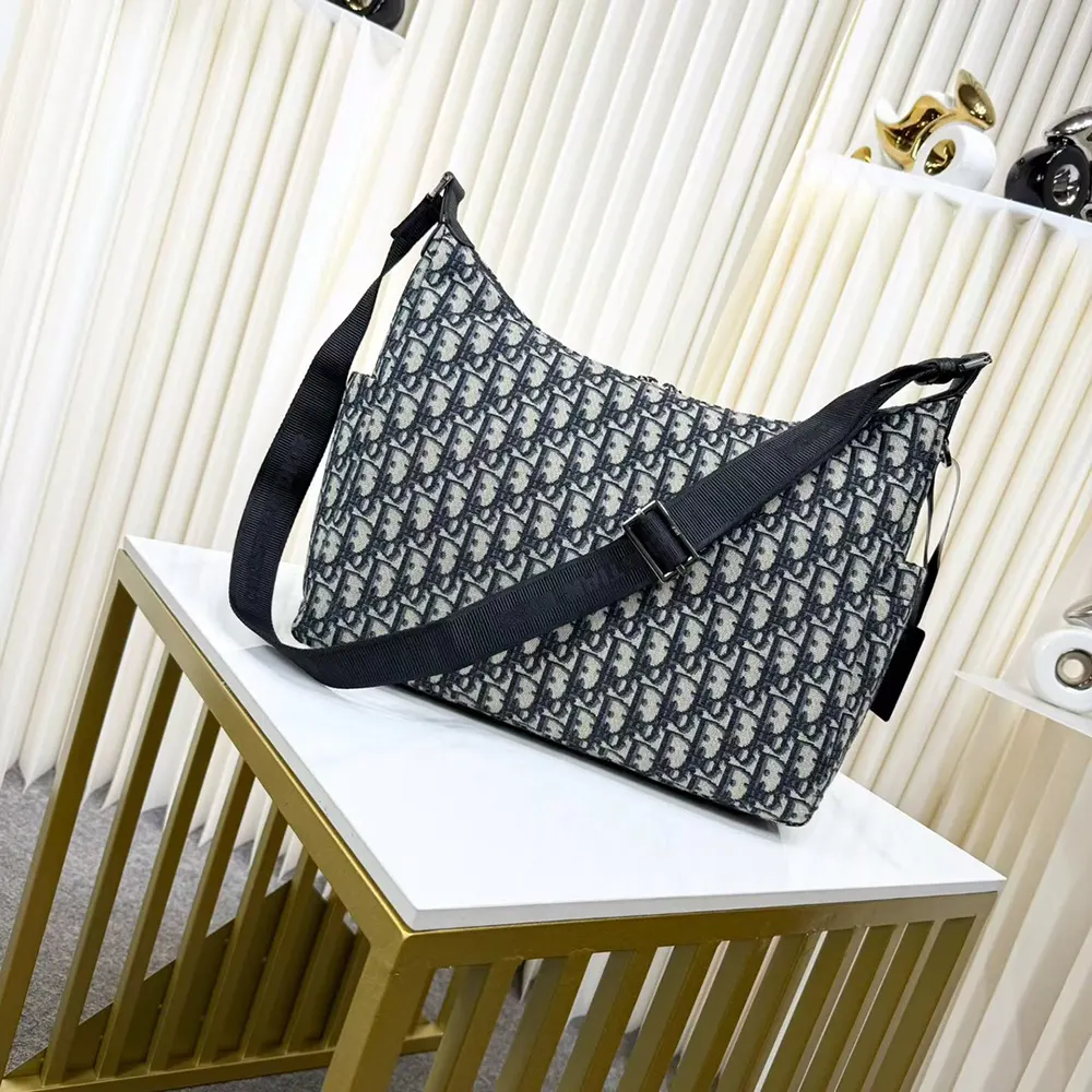 Side angle showing soft hobo silhouette and shoulder strap of Dior bag