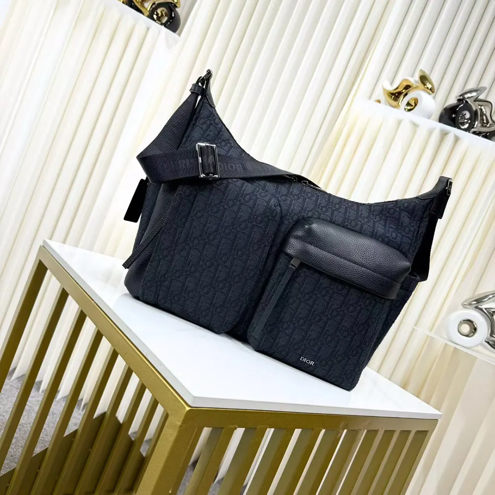 Close-up of black grained calfskin and silver hardware on Dior Men Medium Rider Soft Hobo Bag
