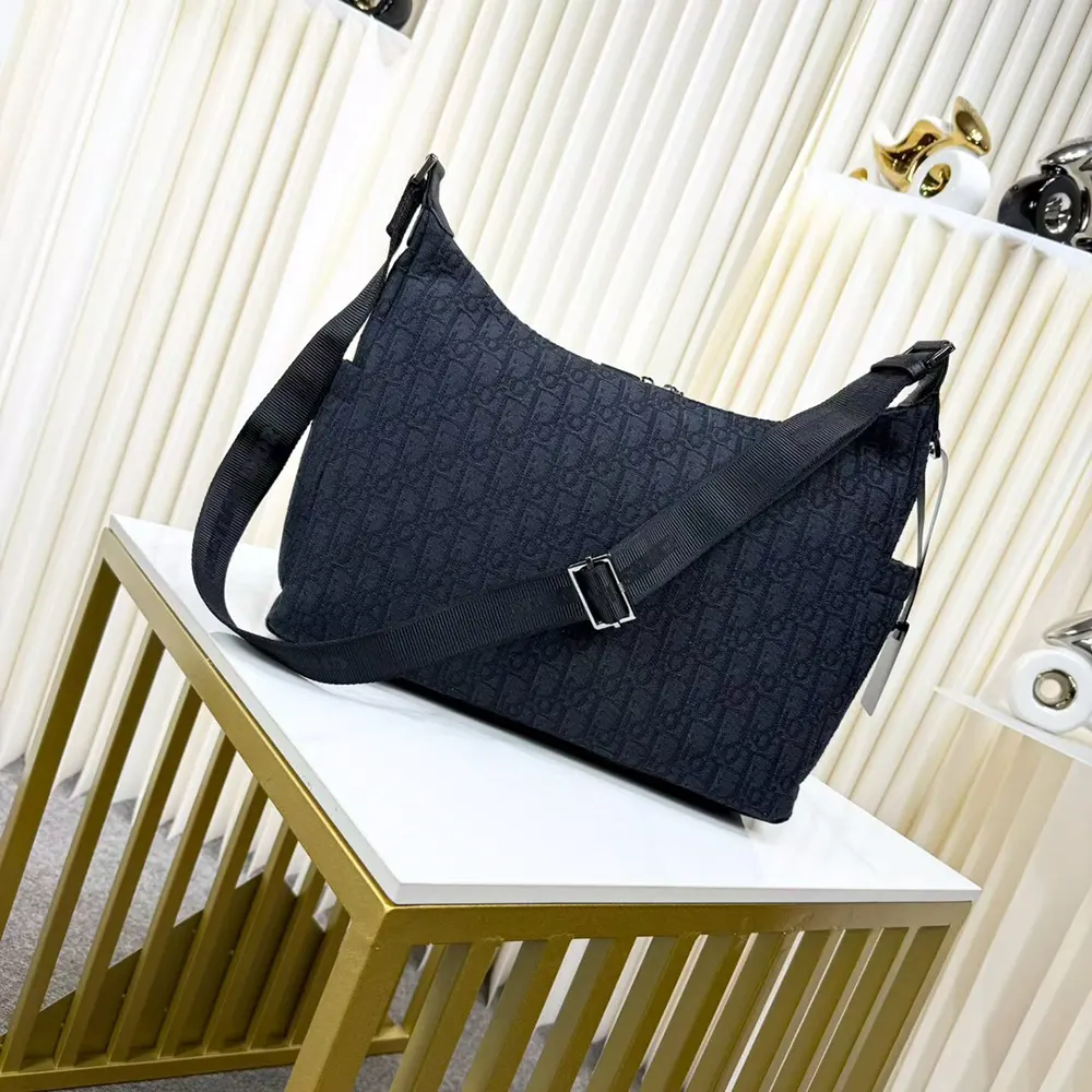 Side angle showing silhouette and shoulder strap of Dior Men Medium Rider Soft Hobo Bag