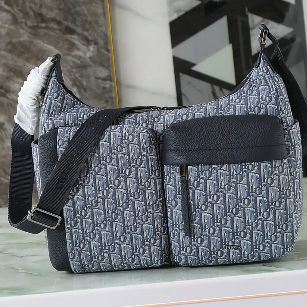 Close-up of silver hardware and blue grained calfskin on Dior Men Medium Rider Soft Hobo Bag