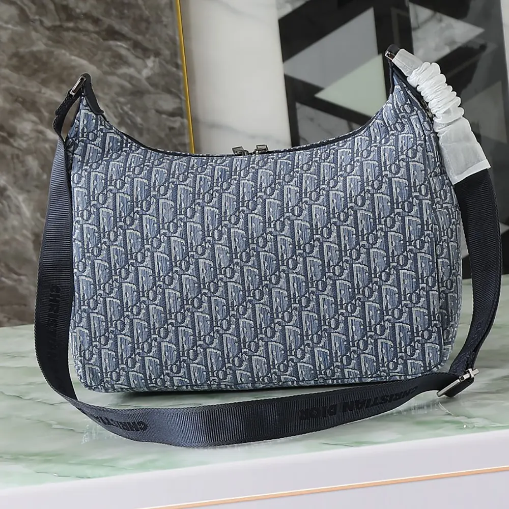 Side profile showing soft hobo silhouette of Dior Men Medium Rider Soft Hobo Bag