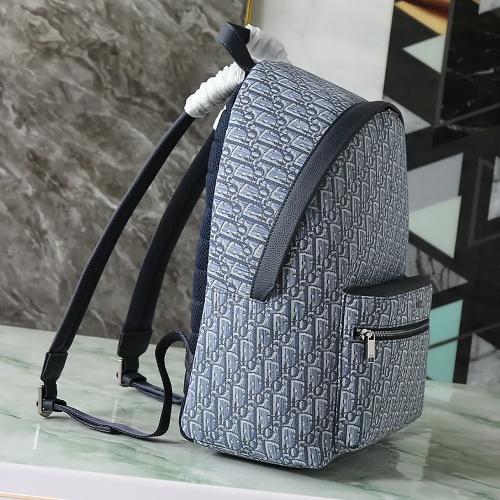 Side profile showing zip and gunmetal hardware on Dior Men Rider Backpack