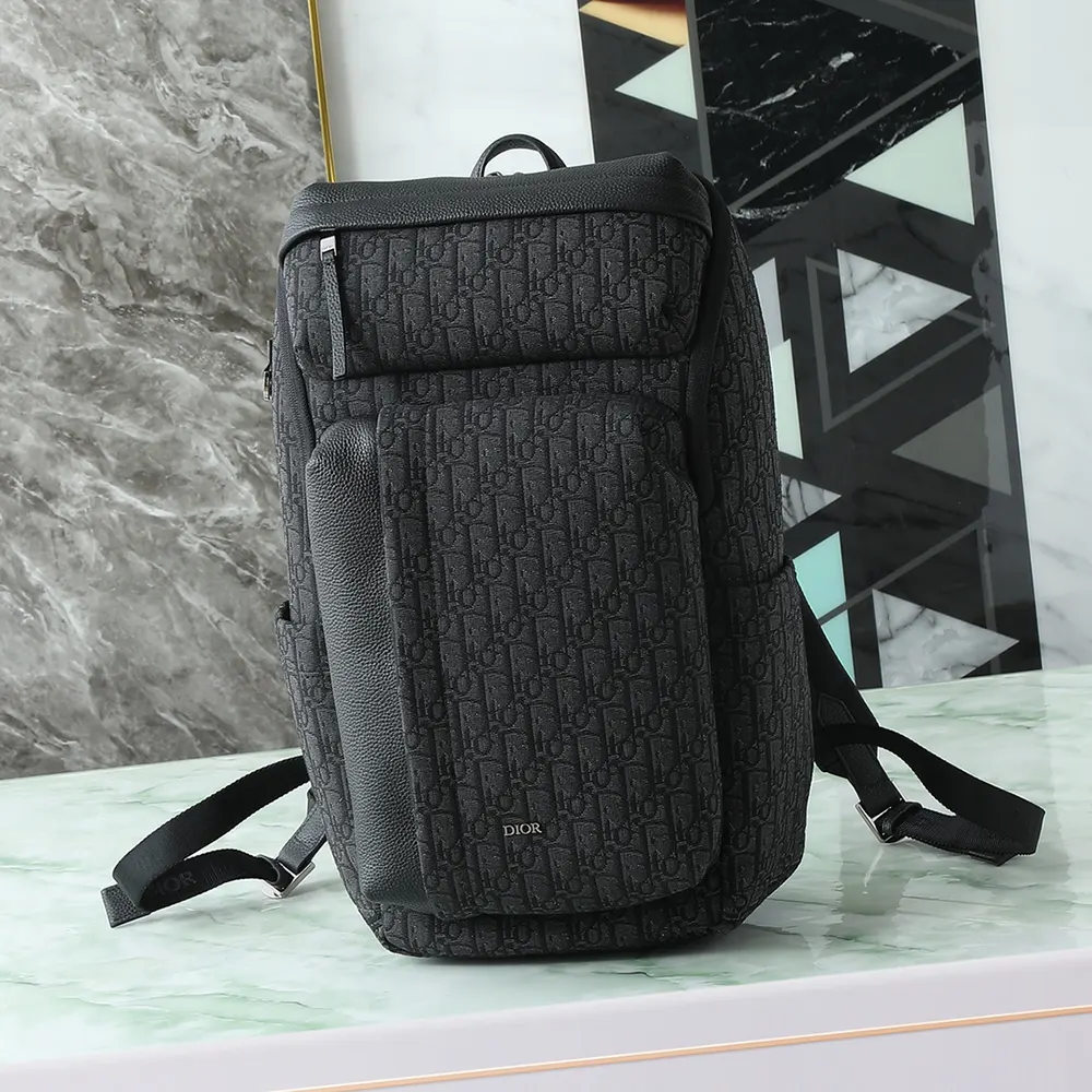 Close-up of black grained calfskin and silver hardware on Dior Men Rider Soft Zipped Backpack