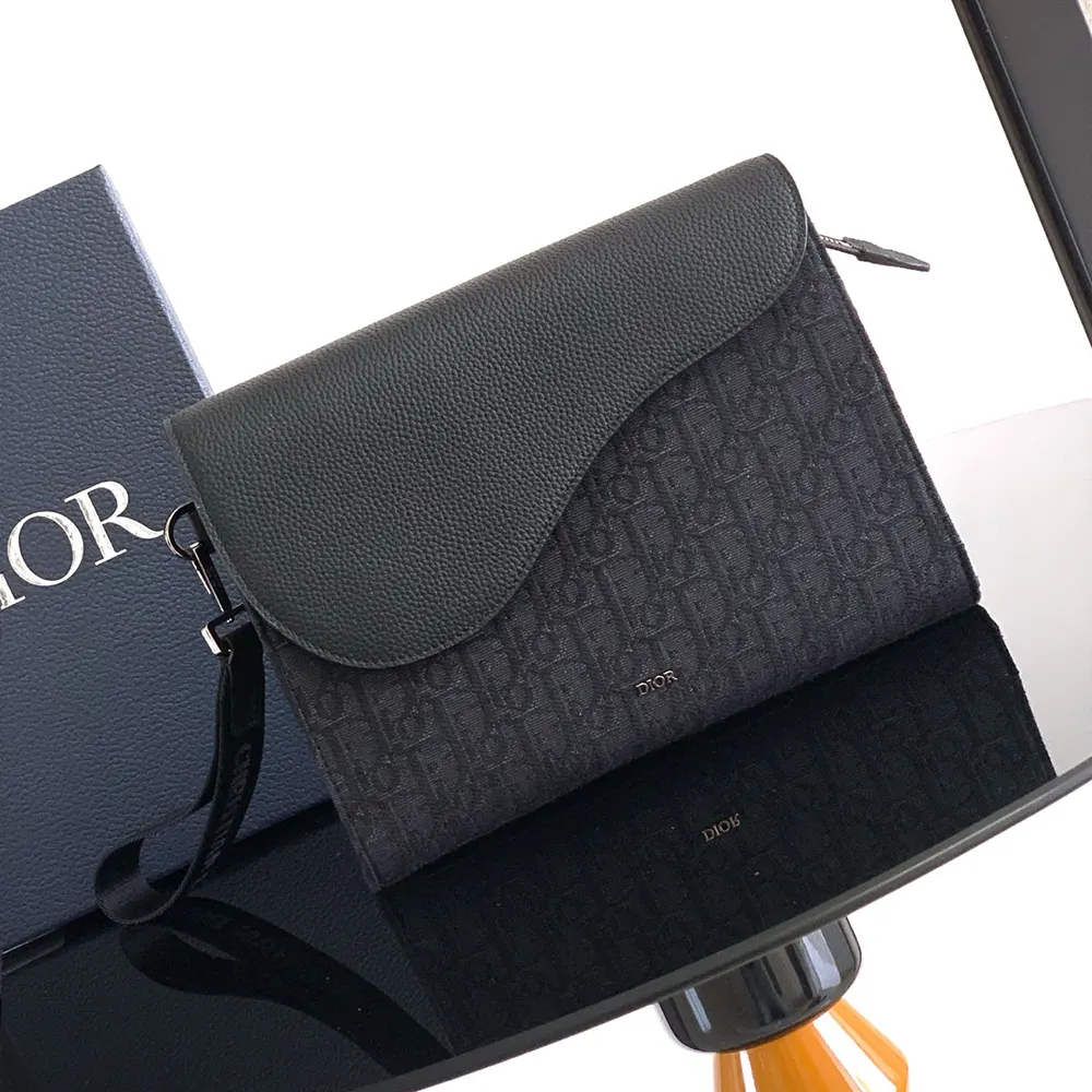 Close-up of black grained calfskin and silver hardware on pouch