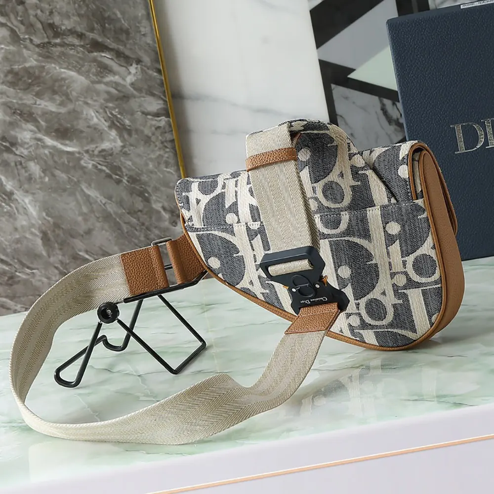Side angle showing adjustable shoulder strap of Dior Men Saddle Bag