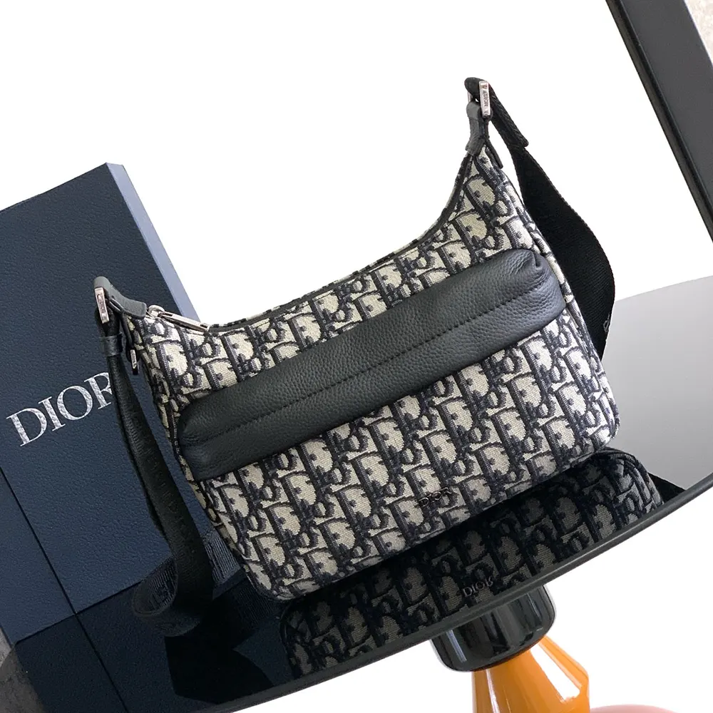 Close-up of black grained calfskin detail on Dior Men Small Rider Soft Hobo Bag