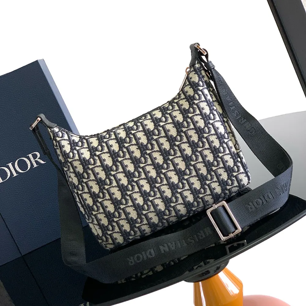 Side angle showing silhouette and gunmetal hardware of Dior Men Small Rider Soft Hobo Bag
