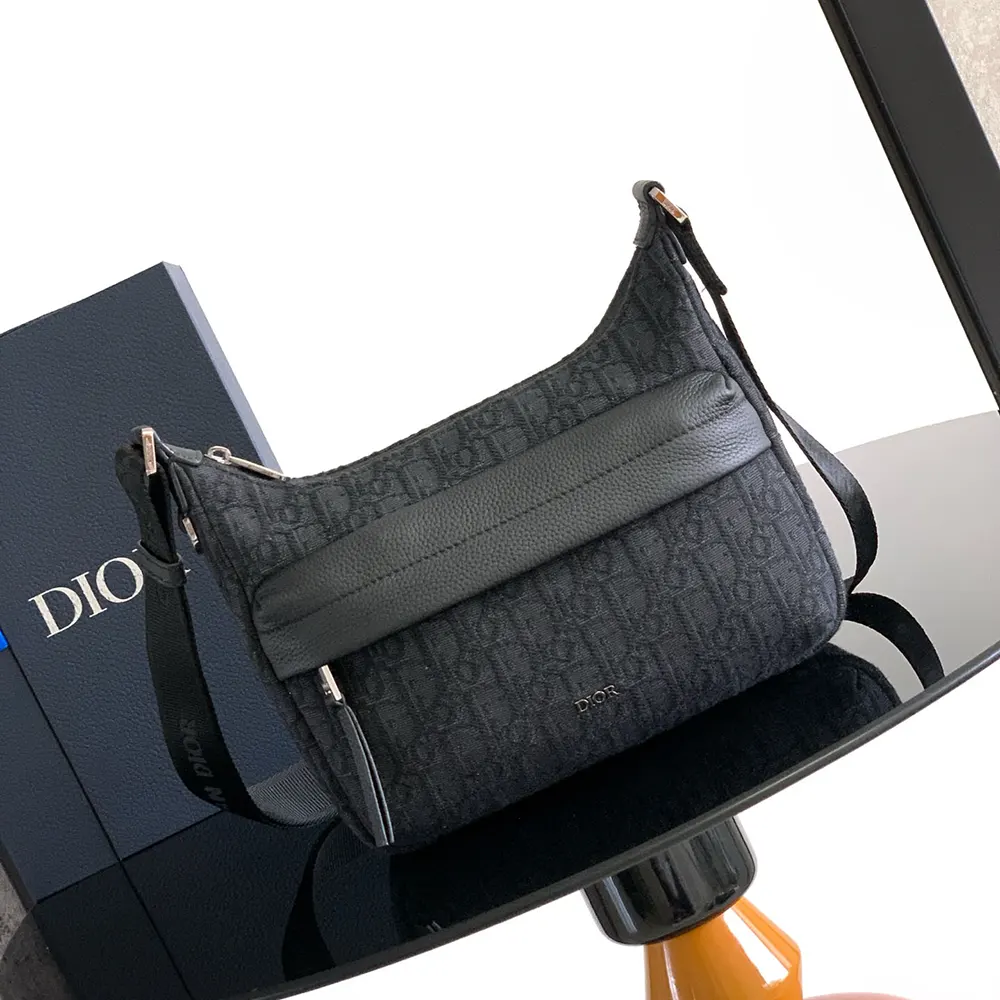 Close-up of silver hardware and black grained calfskin on Dior Men Small Rider Soft Hobo Bag