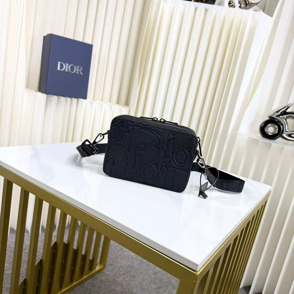 Close-up of zipped closure and strap detail on Dior Men Zipped Pouch
