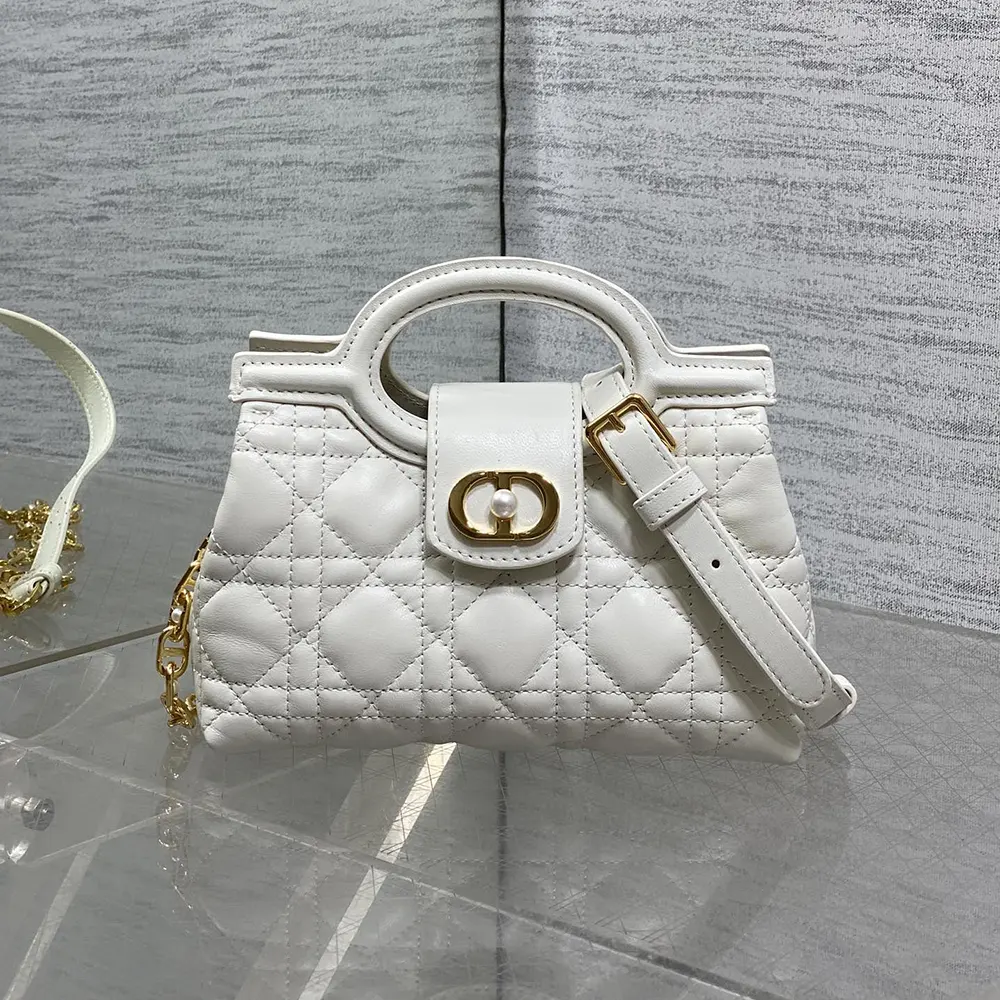 Side angle showing top handle and quilting of Dior Jolie Mini Bag