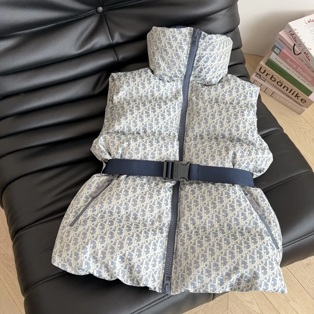 Close-up of blue and white Dior Oblique quilting on DiorAlps Belted Vest