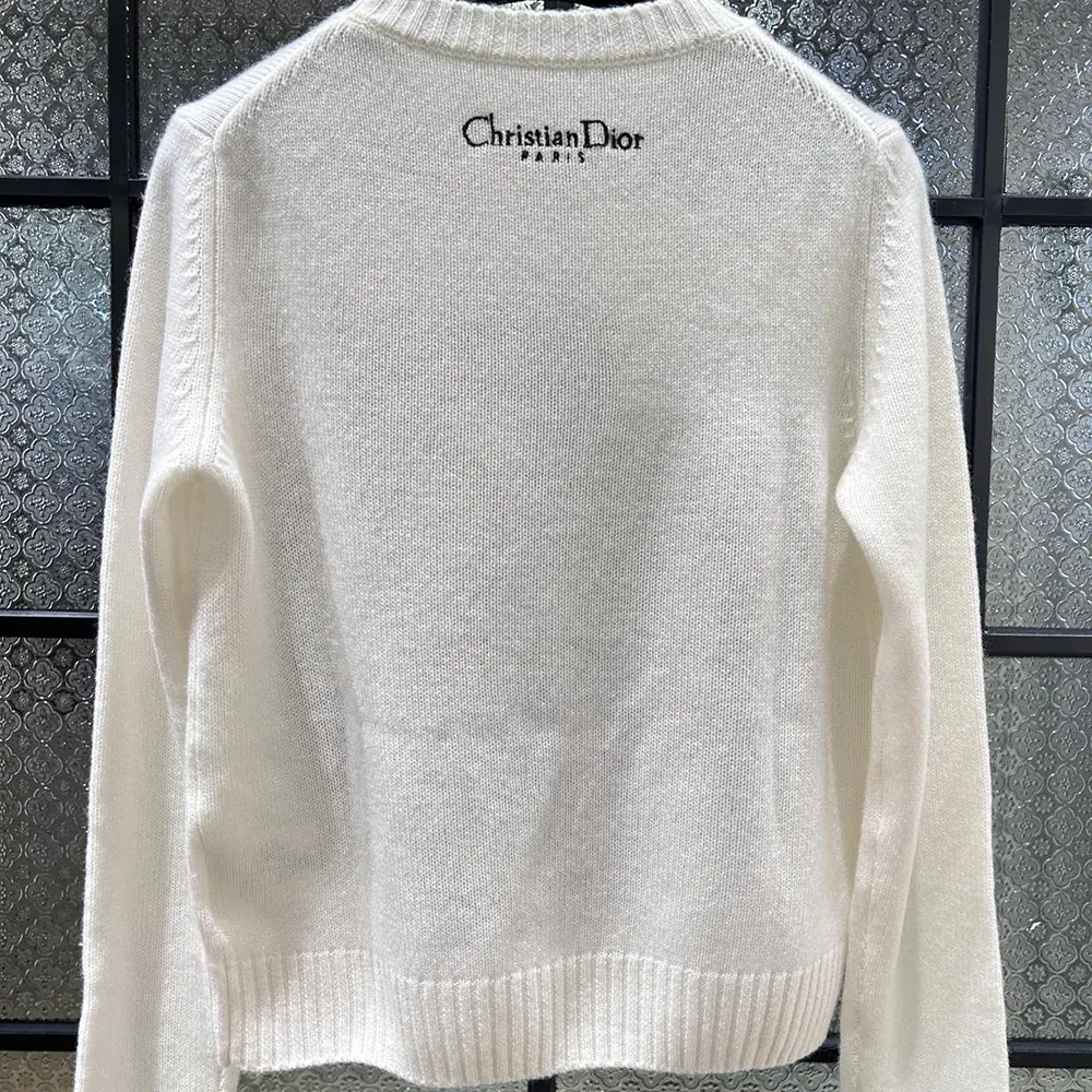 Side angle showing ribbed cuffs and fit of Dior Women Embroidered Sweater