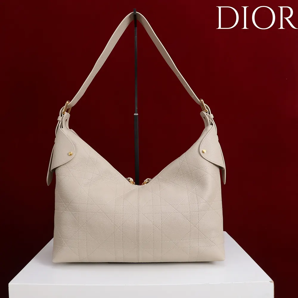 Side angle showing silver hardware and strap of Dior Women Large Dior Voyage Bag