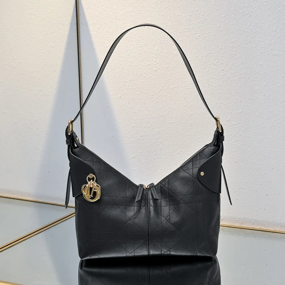Close-up of gold-tone hardware on Dior Women Small Dior Voyage Bag