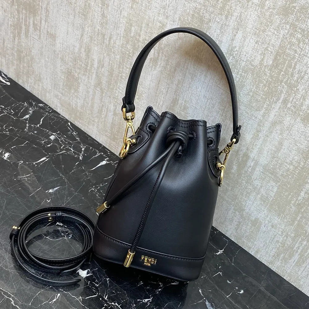 Close-up detail of Fendi logo hardware on black leather mini-bag