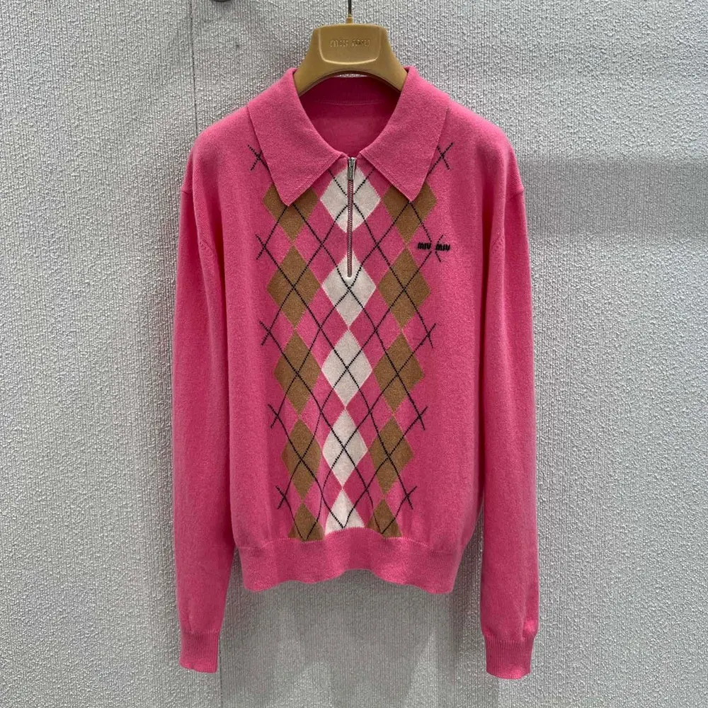 Close-up of half-zip and branded pull on pink Miu Miu polo shirt