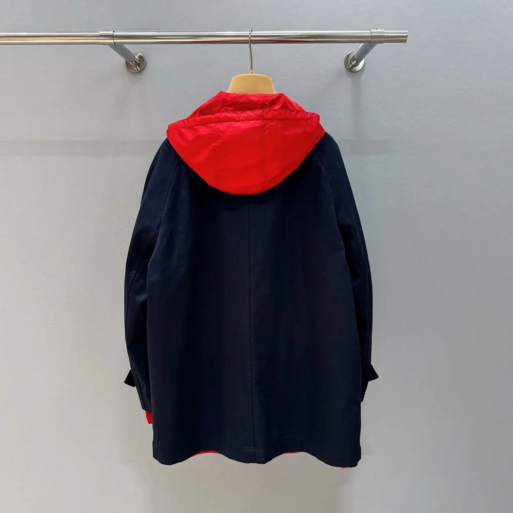Side angle highlighting tailored silhouette of Miu Miu double-breasted navy jacket