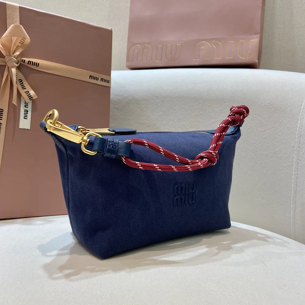 Close-up of navy gabardine fabric and silver hardware details