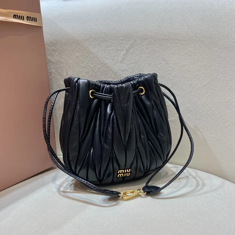 Side angle showing slim silhouette of Miu Miu Women Matelassé Nappa Leather Pouch-Black