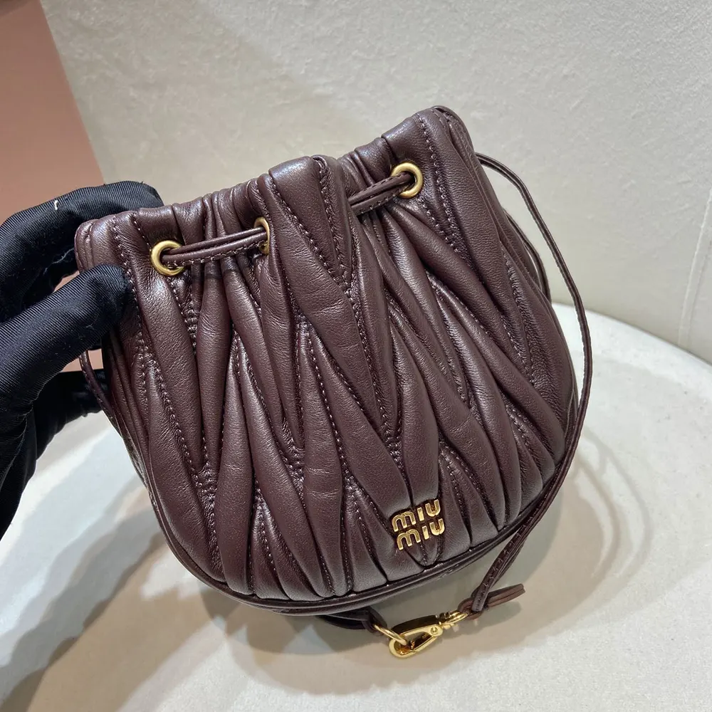 Side angle of Miu Miu Women Matelassé Nappa Leather Pouch-Burgundy showing strap detail