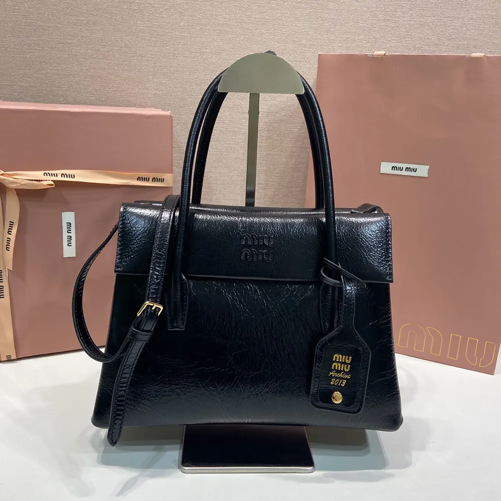 Close-up of polished silver hardware on Miu Miu Women Solitaire Shiny Leather Bag-Black