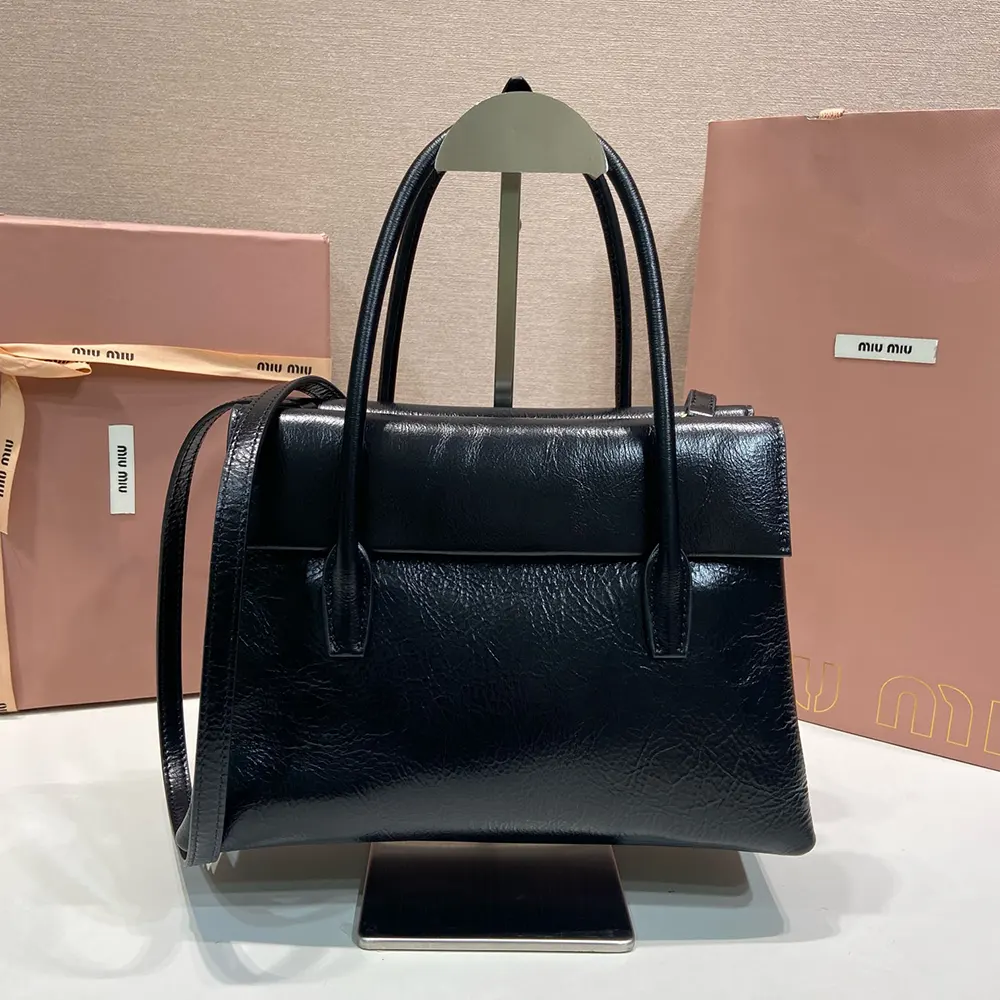Side angle showing silhouette and adjustable strap of Miu Miu Women Solitaire Shiny Leather Bag-Black