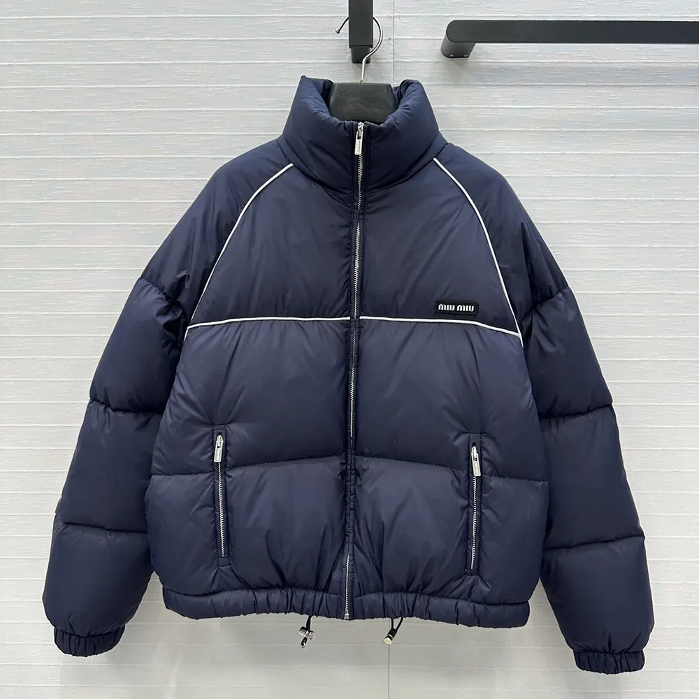 Close-up of zipped closure and logo hardware on Miu Miu down jacket