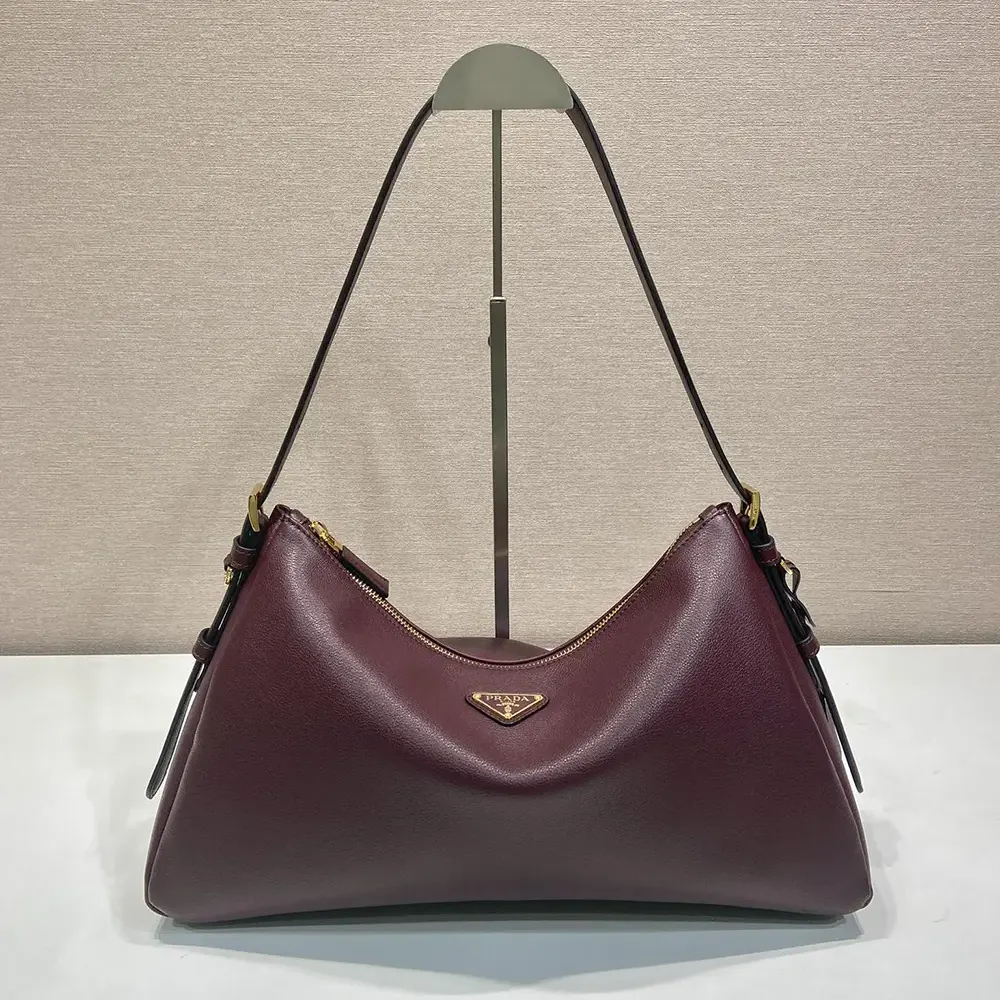 Close-up of gold-tone hardware on Prada Women Aimée shoulder bag