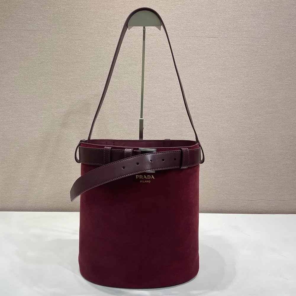 Close-up of buckle belt detail on Prada Women Buckle Belted Suede Bucket Bag-Burgundy
