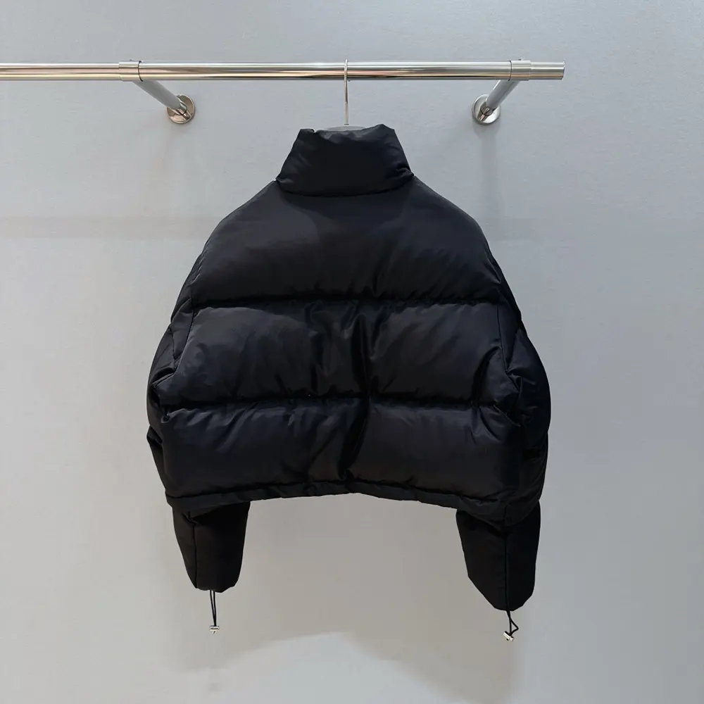 Side angle highlighting tailored silhouette of Prada Women Cropped Re-Nylon Down Jacket-Black