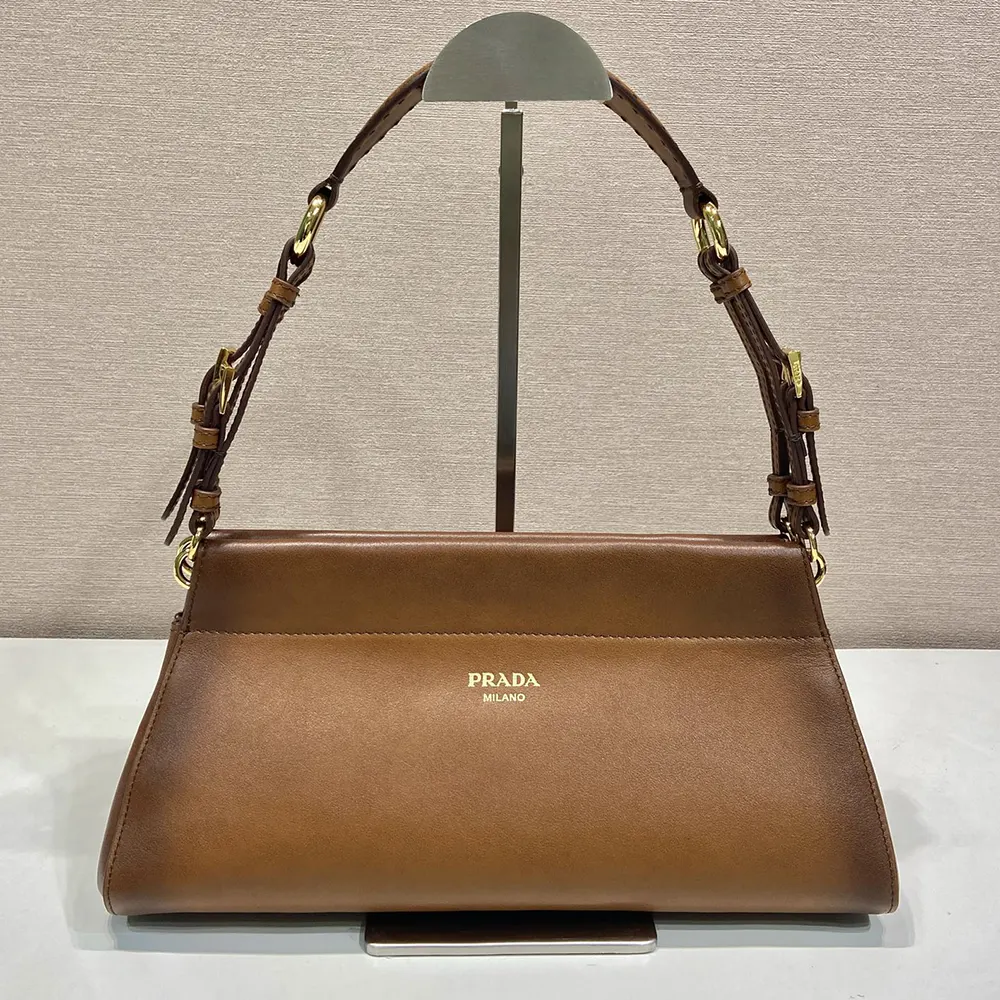 Close-up on silver-tone hardware and magnetic snap of Prada Women Enchaîné Medium Leather Bag-Brown
