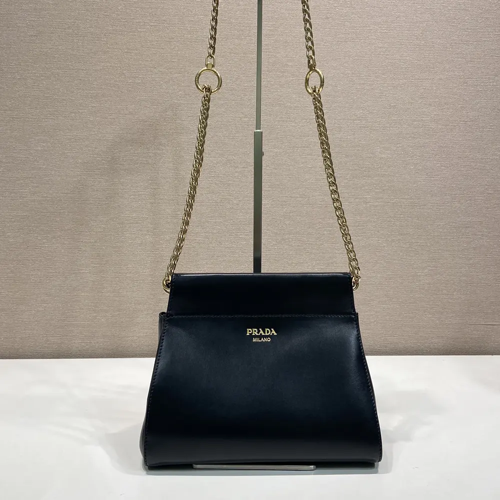 Close-up on silver chain hardware of Prada Women Enchaîné Mini Leather Bag-Black