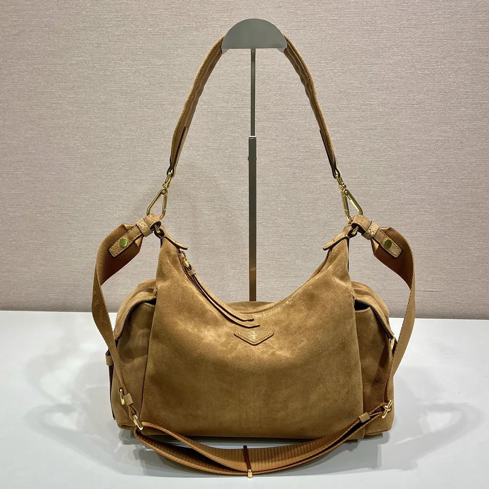 Close-up of rich brown suede texture and metal hardware on Prada bag