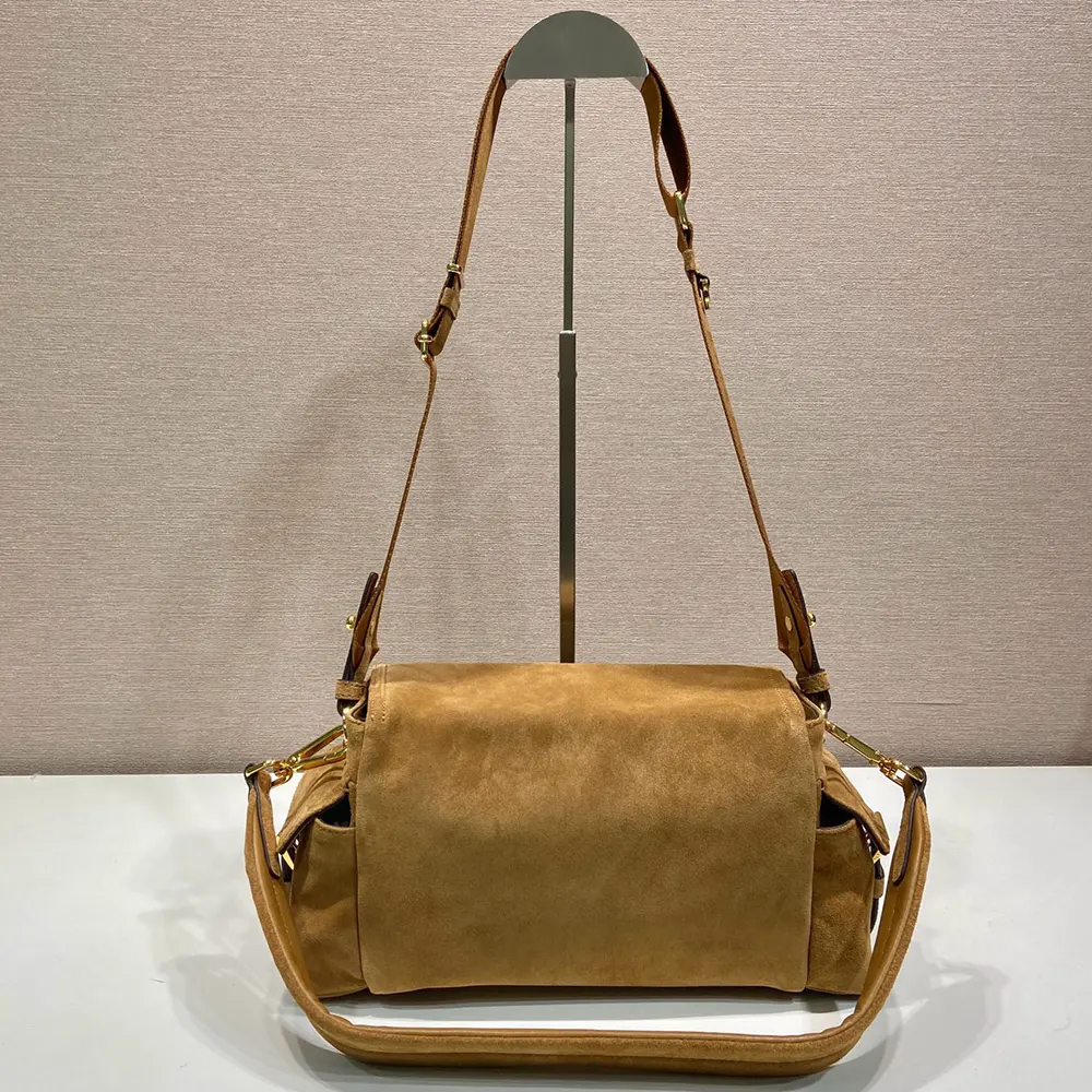 Side profile showcasing the suede texture on Prada Women Explore Medium Suede Shoulder Bag