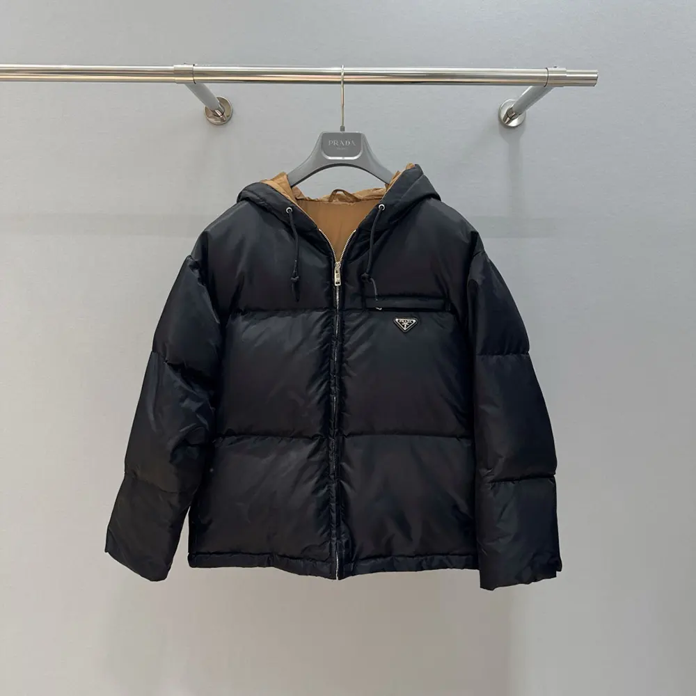 Close-up of Prada triangle logo on black Re-Nylon down jacket