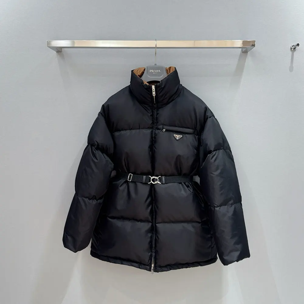 Close-up of Prada triangle logo on black Re-Nylon down jacket