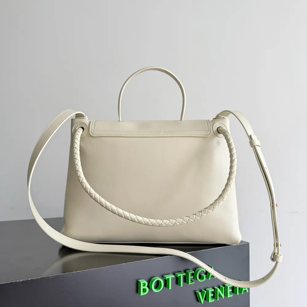 Side angle showing silver hardware and magnetic closure of Bottega Veneta bag