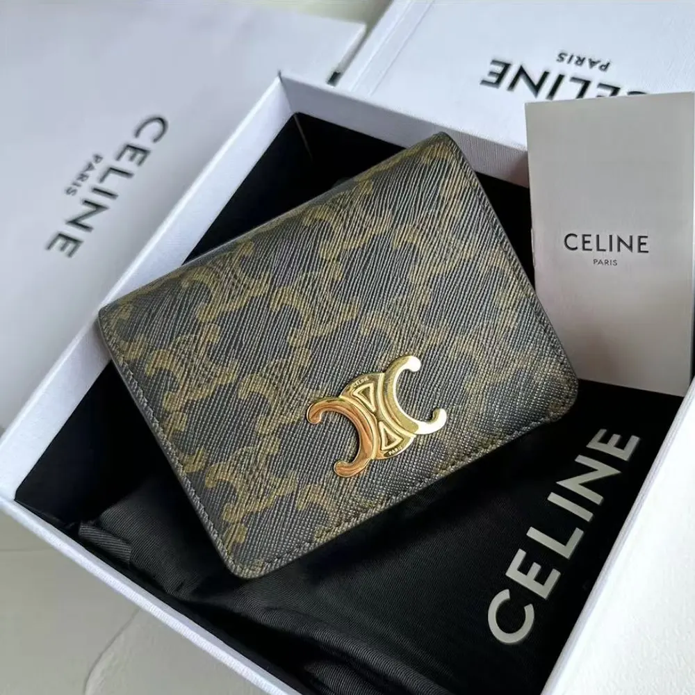 Close-up of gold-tone zipper and Triomphe hardware on wallet