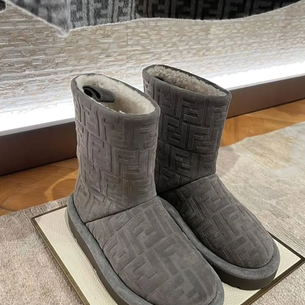 Close-up of gray suede and FF logo hardware on Fendi low boots