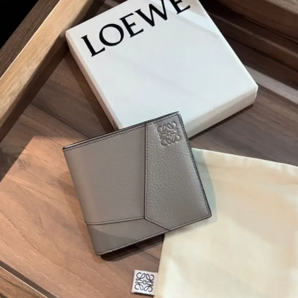 Close-up of Loewe Puzzle stitching on gray calfskin wallet
