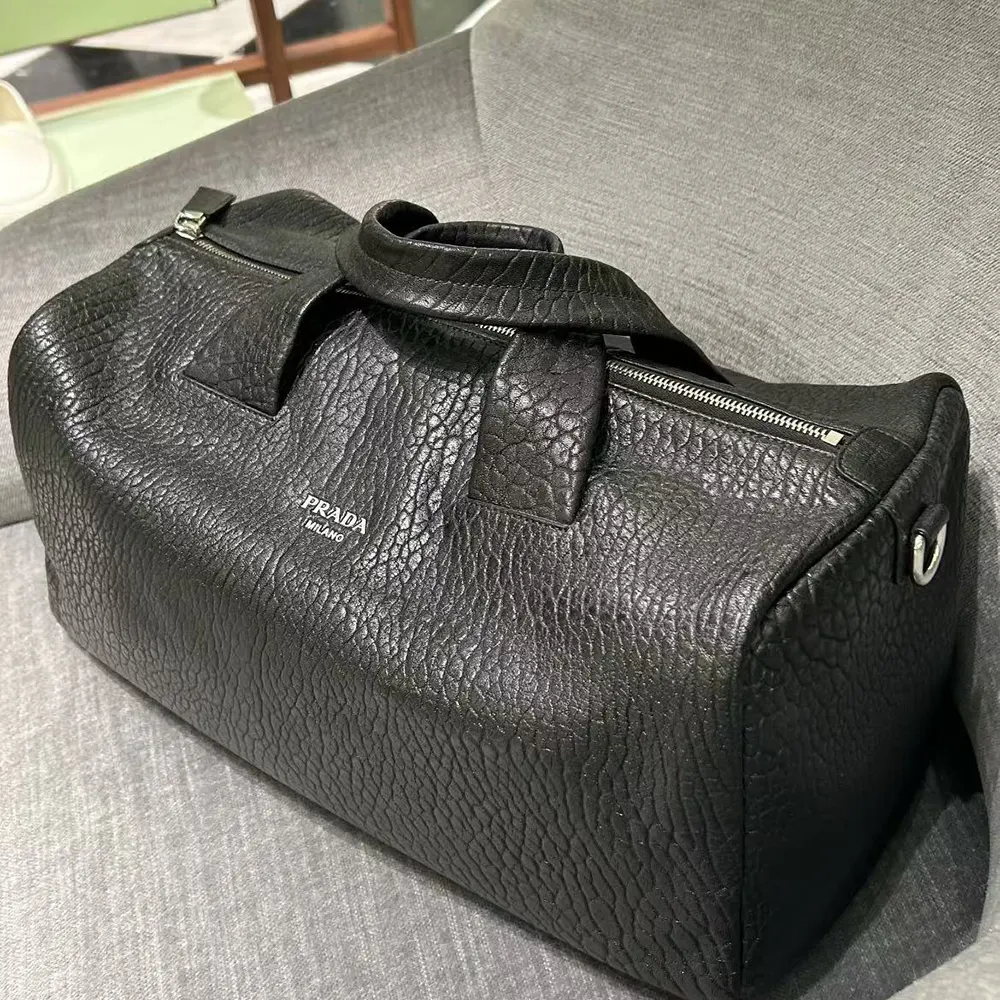 Side angle of Prada Unisex Nappa Leather Duffle Bag-Black with adjustable strap