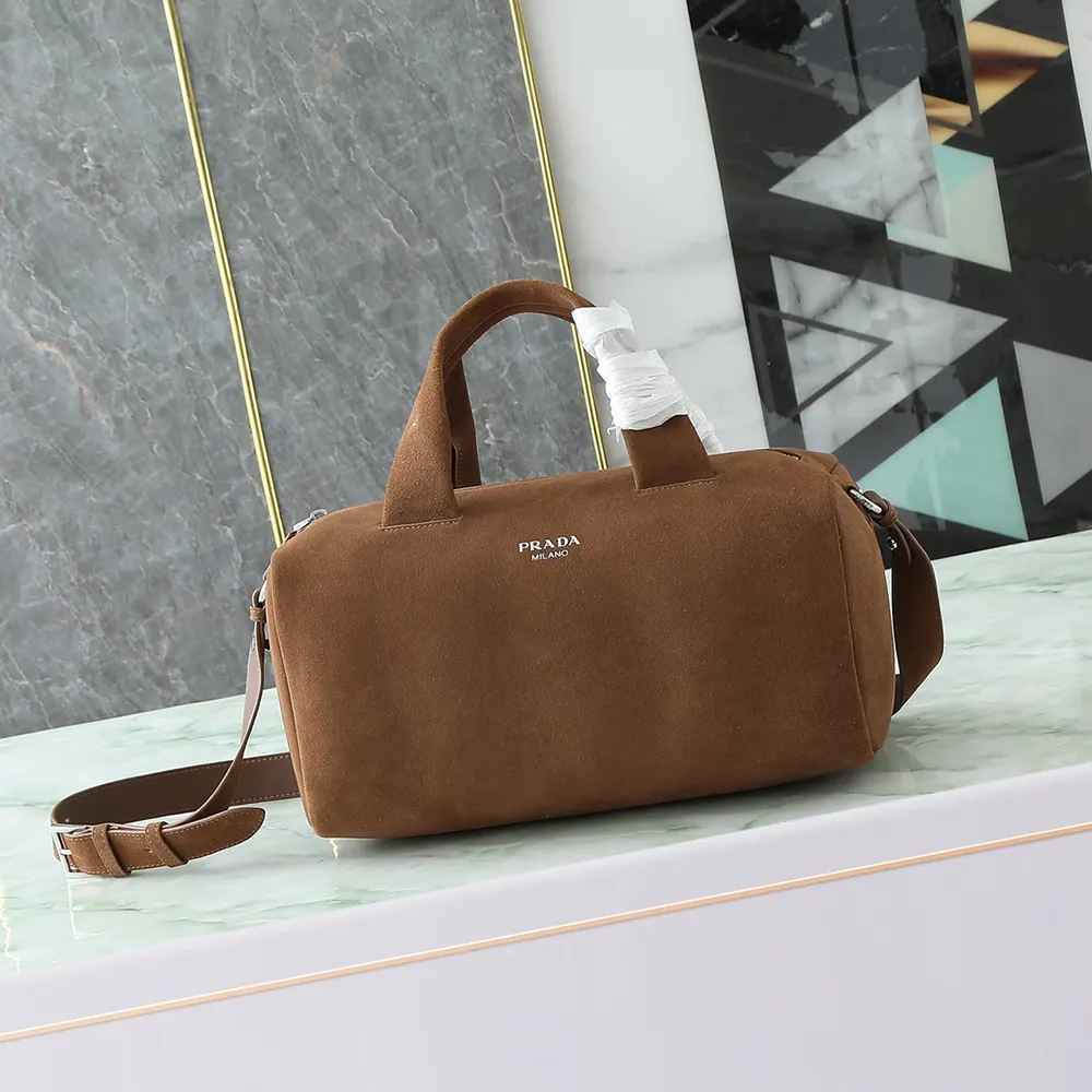 Close-up of brushed gold hardware on Prada Unisex Small Suede Duffle Bag-Coffee