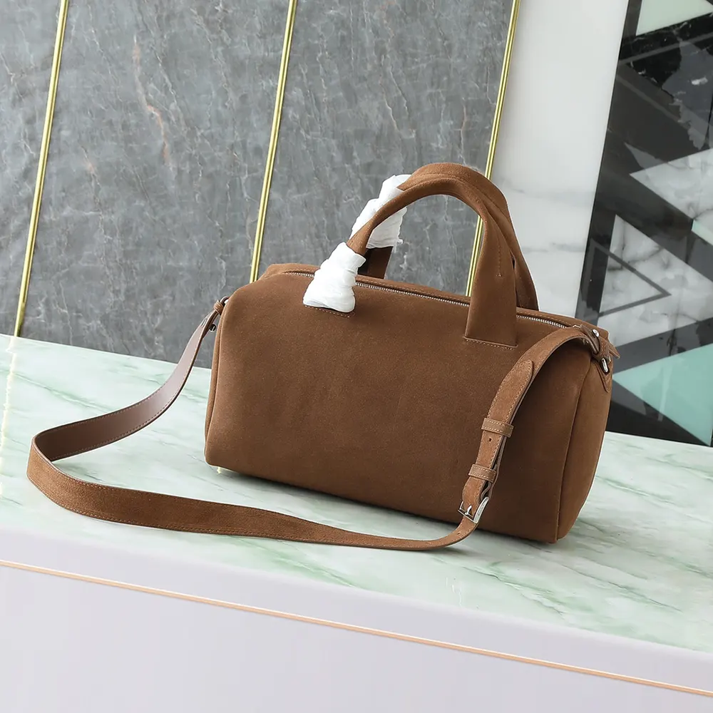 Side view highlighting compact silhouette of Prada Unisex Small Suede Duffle Bag-Coffee