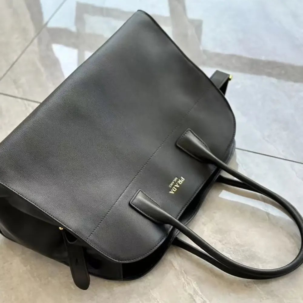 Side angle showing spacious interior of Prada Women Large Leather Tote Bag-Black