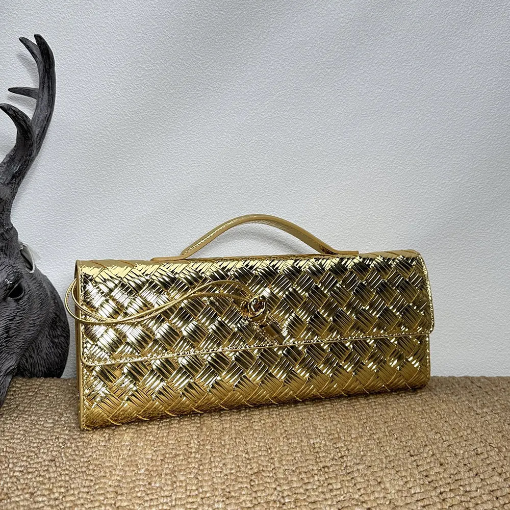 Side angle showing compact silhouette of Bottega Veneta Women Andiamo Clutch-Gold