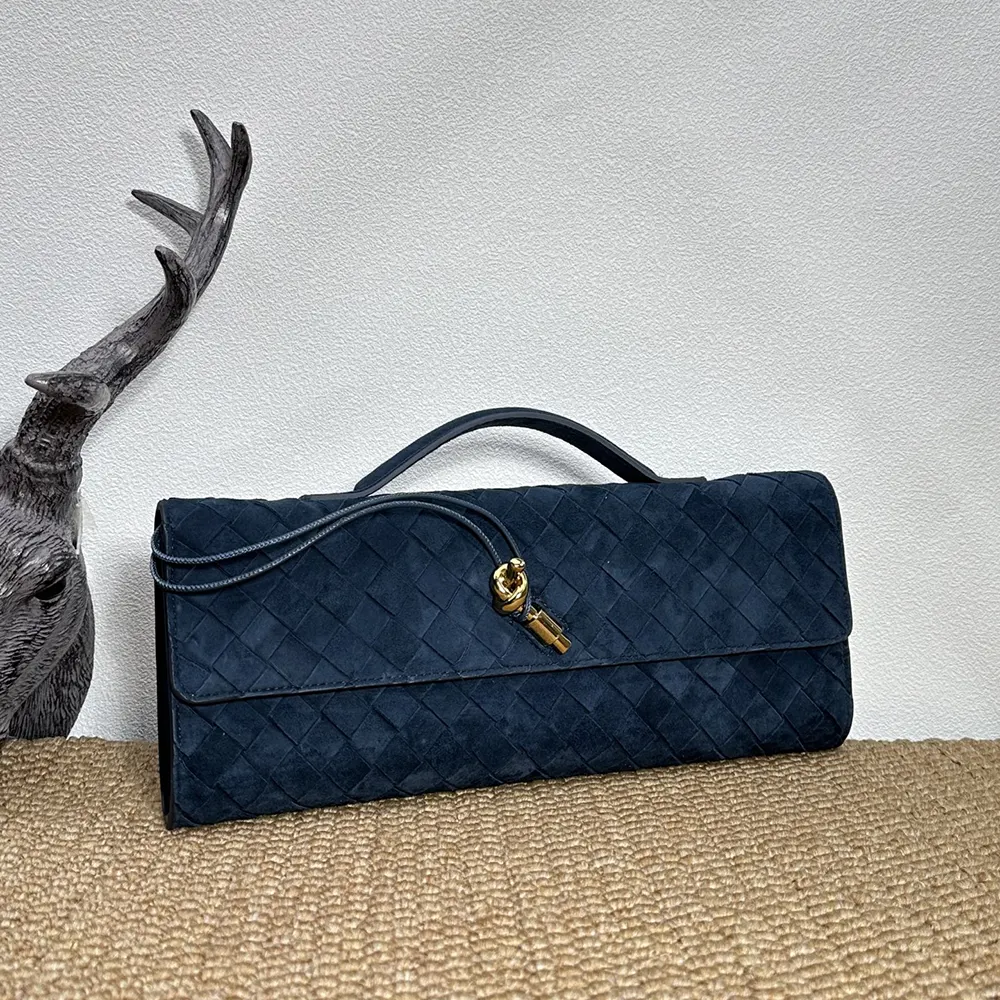 Side angle showing slim silhouette of Bottega Veneta Women Andiamo Clutch-Navy