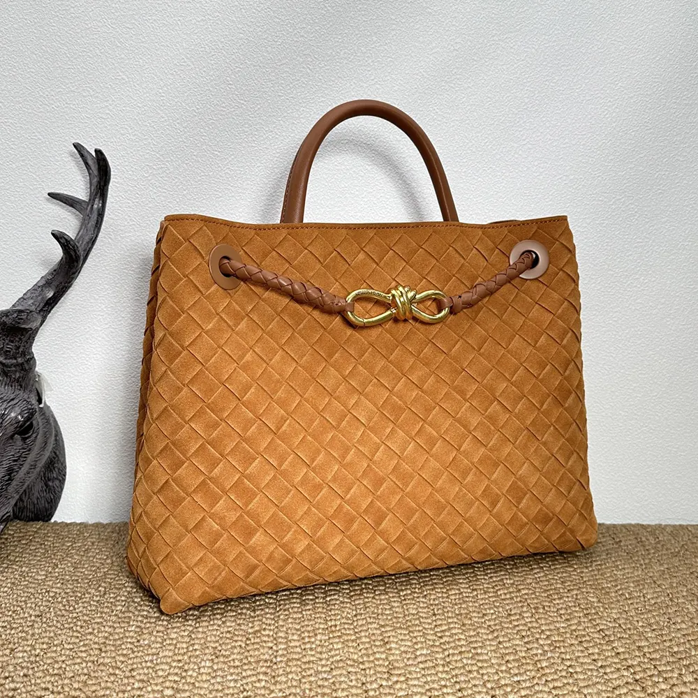 Side angle showing strap and flap closure of Bottega Veneta Women Large Andiamo-Brown